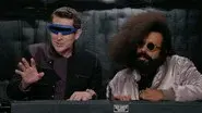 Reggie Watts Wears a Purple and Yellow Quilted Sweatshirt still
