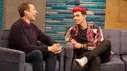 Joe Jonas Wears a Maroon and Gold Letterman Jacket With White Sneakers still